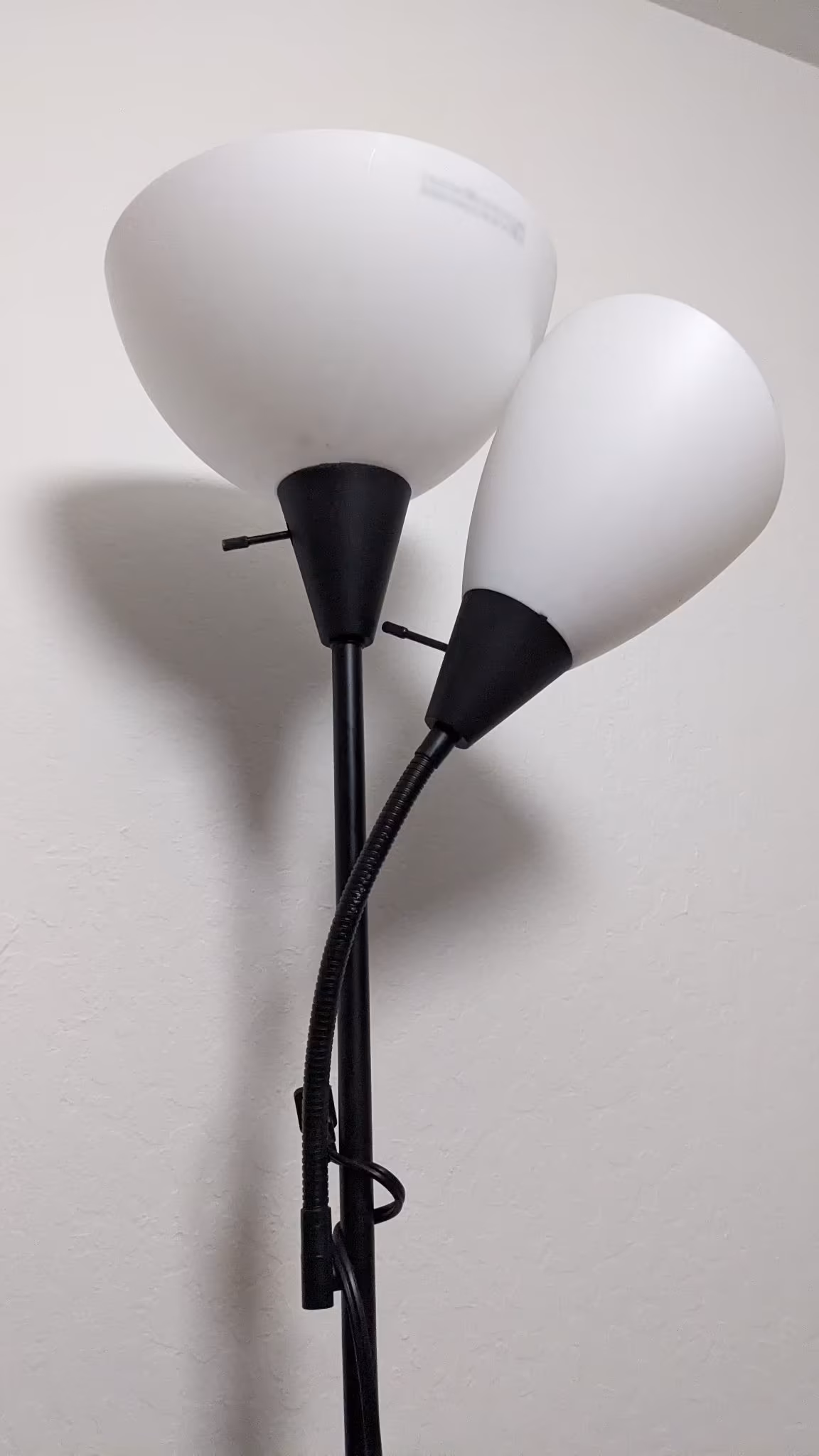Top view of simple black base lamp with two white shades light bulb